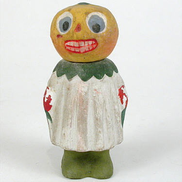 “ Composition "Pumpkin Girl" candy container painted in tones of yellow, green, blue, red, and white; marked "Germany;" circa 1910. Height=4.5 Price: $795.00”