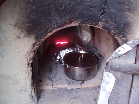 wood fired clay bake oven with stockpot and covered roast